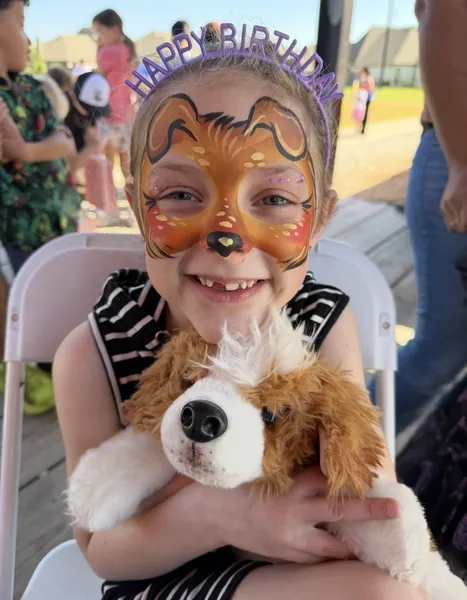 Happy children with waterproof face painting at a summer celebration