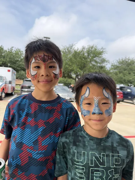 Children with face painting at an outdoor summer festival